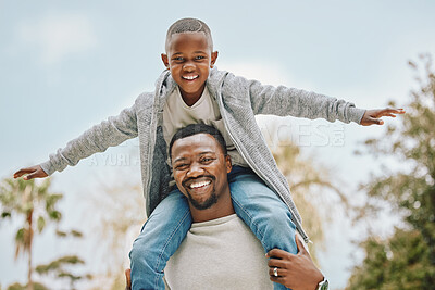 Buy stock photo Cropped portrait of an adorable little boy sitting on his father's shoulders outside
