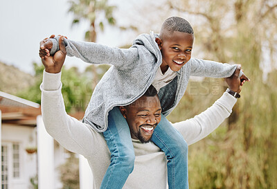 Buy stock photo Cropped portrait of an adorable little boy sitting on his father's shoulders outside