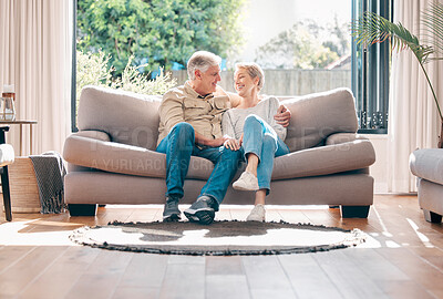 Buy stock photo Shot of a happy senior couple relaxing on the sofa at home