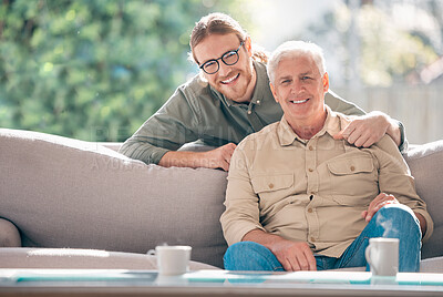 Buy stock photo Portrait of a young man relaxing with his father on the sofa at home