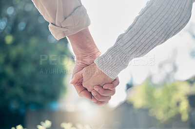 Buy stock photo Shot of an unrecognisable senior couple holding hands