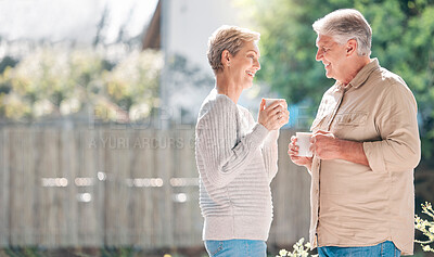 Buy stock photo Shot of a happy senior couple enjoying a relaxing coffee break in the garden at home