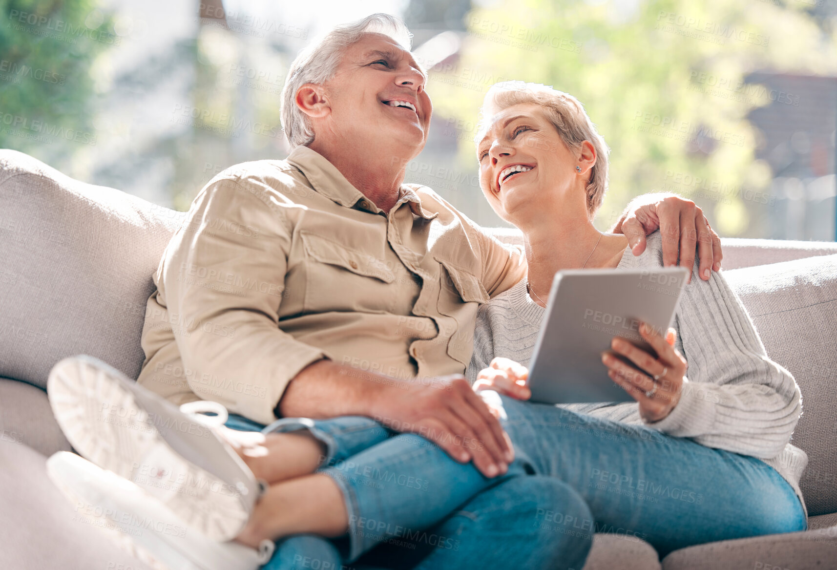 Buy stock photo Happy, senior couple and sofa with tablet for browsing social media, streaming video and reading funny meme. Elderly, people and laughing with digital of communication, comic article or love at house