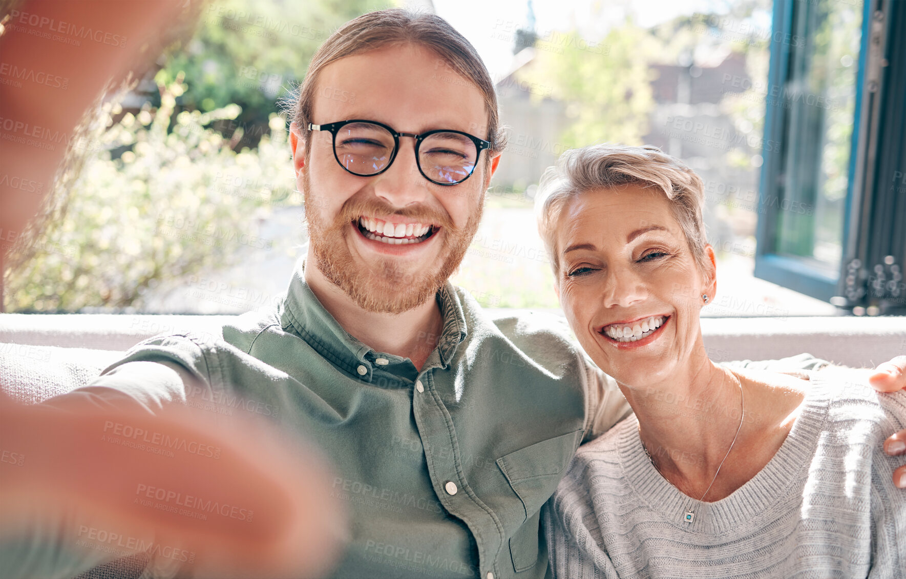 Buy stock photo Portrait, mother and son for selfie on sofa for profile picture, social media post or bonding with love in living room. Happy, woman and man for family photography, hug and support of memory at house