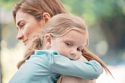 Buy stock photo Shot of a young woman carrying her adorable little girl outdoors