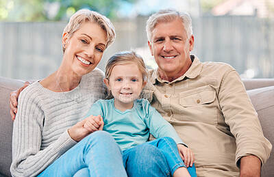 Buy stock photo Portrait of an adorable little girl relaxing with her grandmother and grandfather on the sofa at home