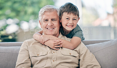 Buy stock photo Portrait of an adorable little boy relaxing with his grandfather on the sofa at home