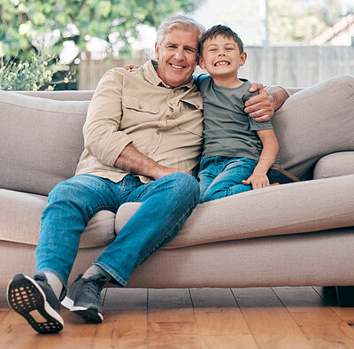 Buy stock photo Portrait of an adorable little boy relaxing with his grandfather on the sofa at home