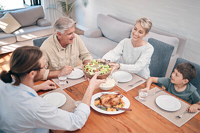 Buy stock photo Shot of a family enjoying a meal together at home