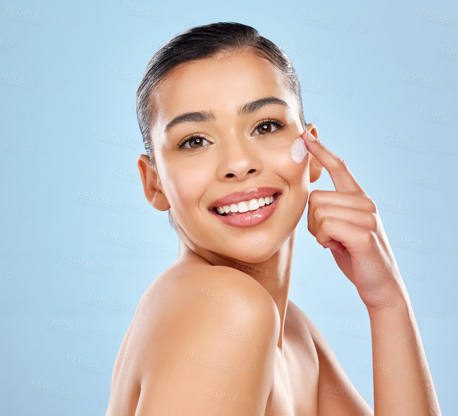 Buy stock photo Cream, portrait and woman in studio with hand for skincare treatment, cosmetics or dermatology spa on blue background. Beauty, body and model with smile for shine, moisturizer or wellness mockup