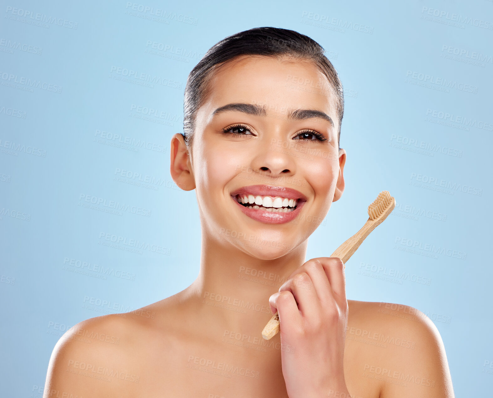 Buy stock photo Woman, portrait and happy with toothbrush in studio, dental care and smile for mouth wellness for hygiene. Bamboo, eco friendly product and blue background, cleaning and teeth or oral health