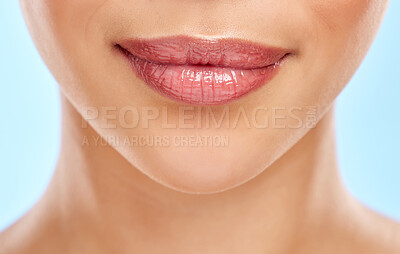 Buy stock photo Studio shot of an unrecognisable woman's lips against a blue background