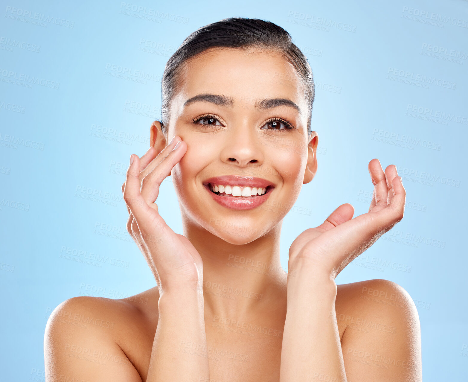 Buy stock photo Portrait, hands and model girl with smile in studio for skincare, glow and beauty or cosmetics. Happy woman, face and results for dermatology, chemical peel and facial for shine by blue background