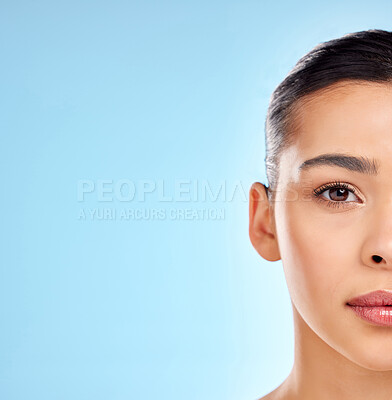 Buy stock photo Half, face and skincare for woman in studio for beauty, glow and wellness with mock up space. Model girl, laser and portrait for dermatology results and chemical peel or facial by blue background 