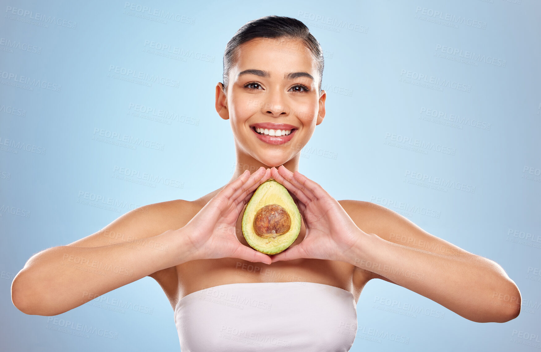 Buy stock photo Woman, portrait and avocado in studio for skincare or beauty, organic and natural cosmetics with vitamin e for healthy skin. Girl, fruit and blue background with omega 3 for collagen and hydration