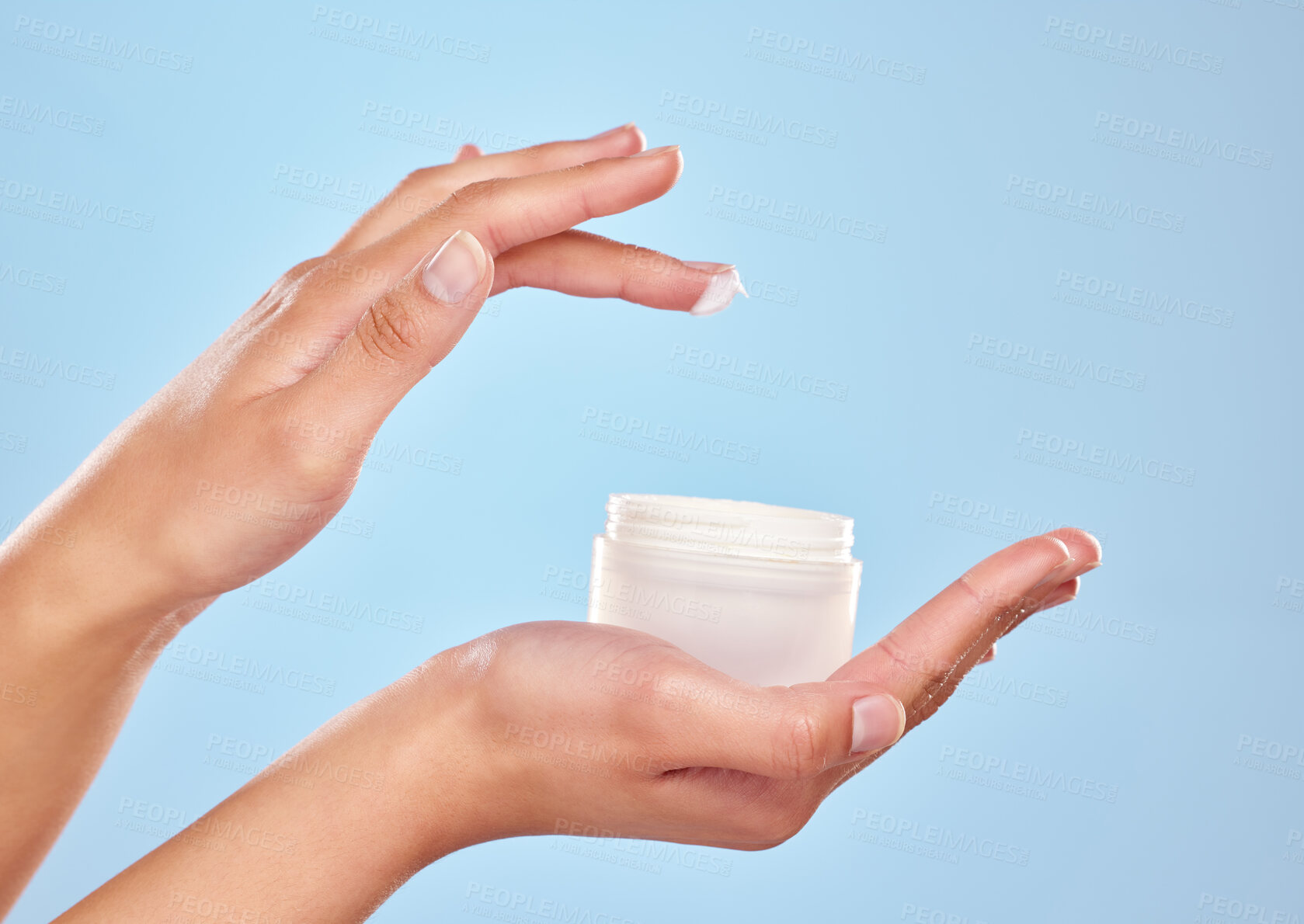 Buy stock photo Woman, hands and cream jar in studio for skincare, sunscreen and cosmetics on blue background. Female person, body care and moisturizer pot for hydrated skin, treatment and container for dermatology