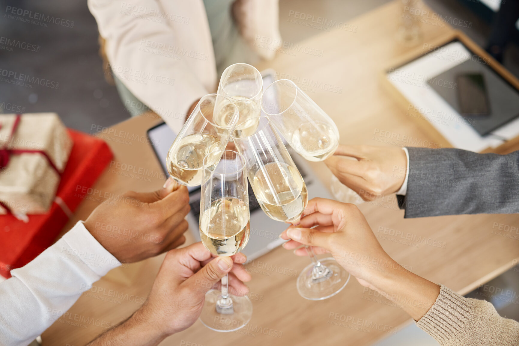 Buy stock photo Shot of a group of unrecognizable businesspeople toasting during a celebration at work