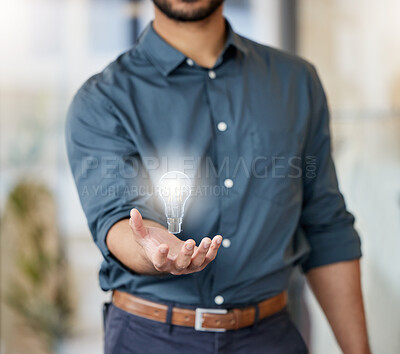 Buy stock photo Shot of an unrecognisable businessman holding a lightbulb in a modern office
