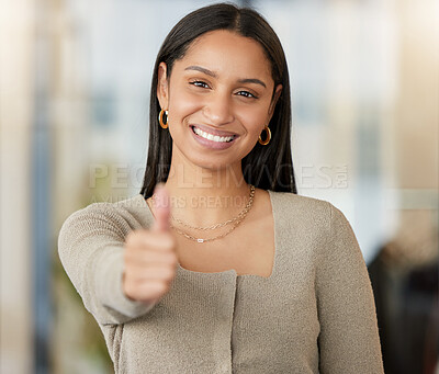 Buy stock photo Portrait of a confident young businesswoman showing thumbs up in a modern office