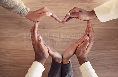 Buy stock photo Business, collaboration and heart hands on a wooden background from above for love in the office. Team building, health and wellness with an employee group in the workplace together for unity