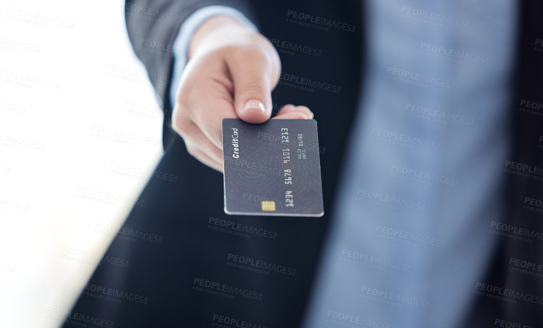 Buy stock photo Shot of an unrecognizable businesswoman holding a credit card at work