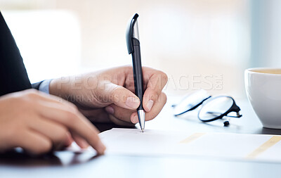 Buy stock photo Shot of an unrecognizable businesswoman going over paperwork in a modern office
