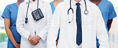 Buy stock photo Shot of a group of unrecognizable doctor standing at a clinic