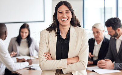 Buy stock photo Shot of a young businesswoman standing with her arms crossed during a meeting at work
