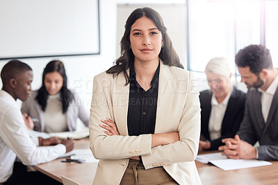 Buy stock photo Shot of a young businesswoman standing with her arms crossed during a meeting at work