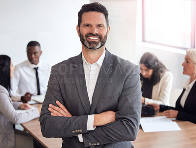Buy stock photo Shot of a mature businessman standing with his arms crossed during a meeting at work