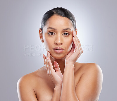 Buy stock photo Serious, portrait and woman with skincare in studio for natural beauty, spa treatment and cosmetics. Female person, dermatology and relax with pride for self care, shine and glow on gray background
