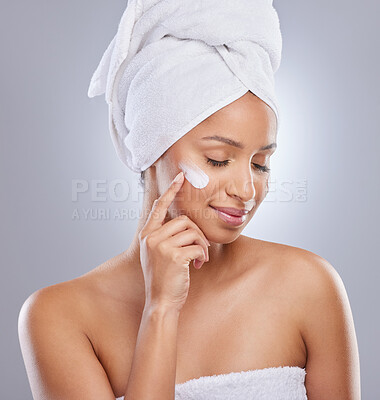 Buy stock photo Studio, woman and towel for cream or cosmetics, moisturizer and hand on white background. Skincare, dermatology and beauty for female person, smile or relax for lotion with glow and product on face