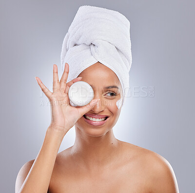 Buy stock photo Shot of an attractive young woman feeling playful while posing with a container of moisturiser in the studio