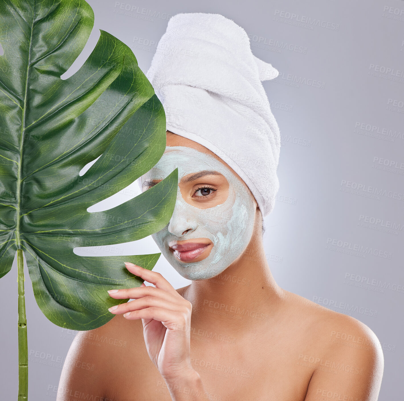 Buy stock photo Leaf, skincare and portrait of woman with face mask in studio for dermatology and treatment on grey background. Plant, facial and female model with diy, beauty and eco friendly wellness body care