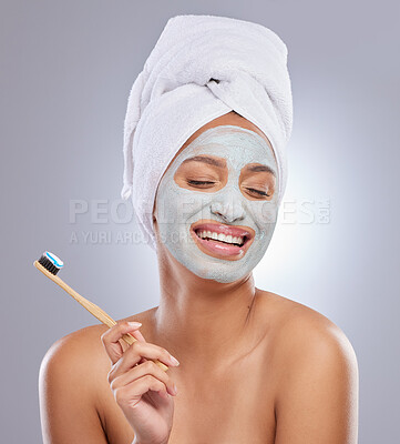 Buy stock photo Shot of an attractive young woman wearing a face mask and holding a toothbrush