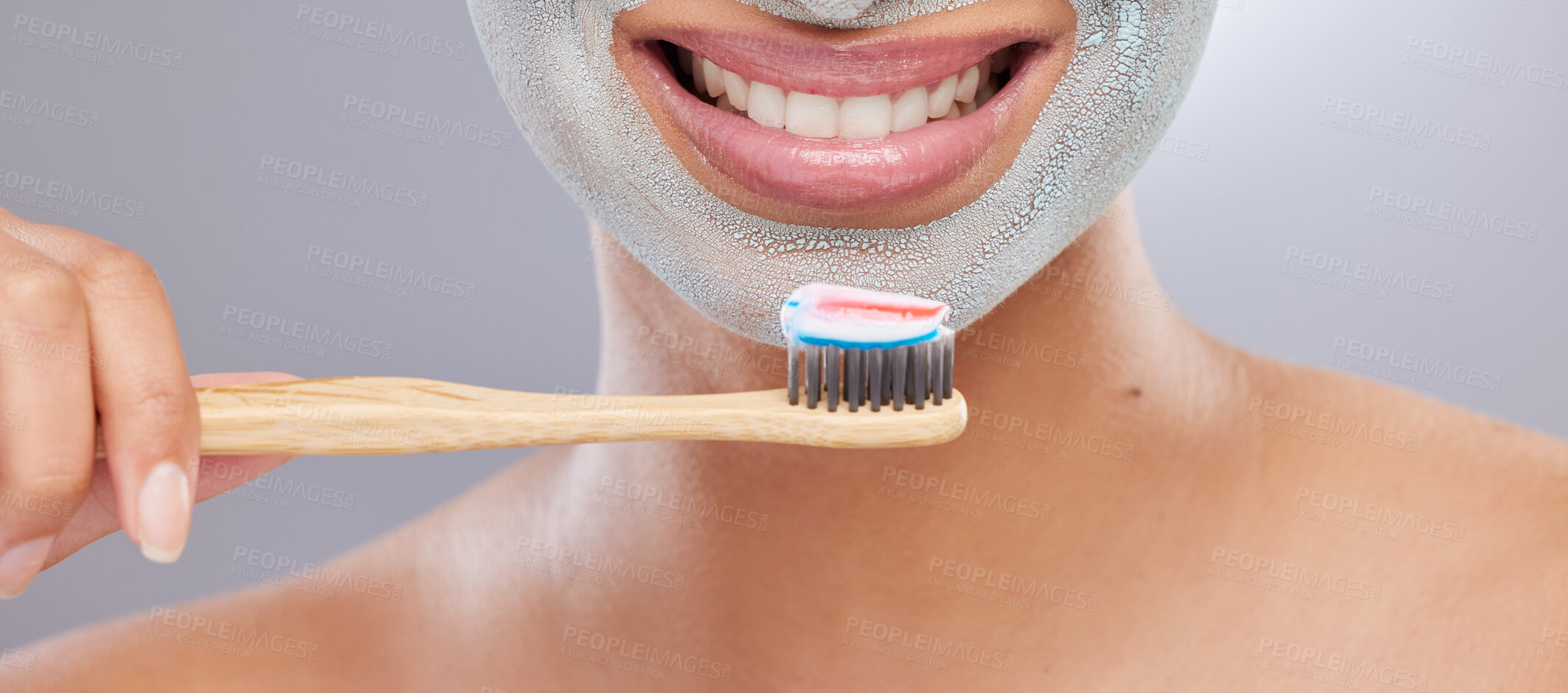 Buy stock photo Cropped shot of an unrecognisable woman wearing a face mask and holding a toothbrush