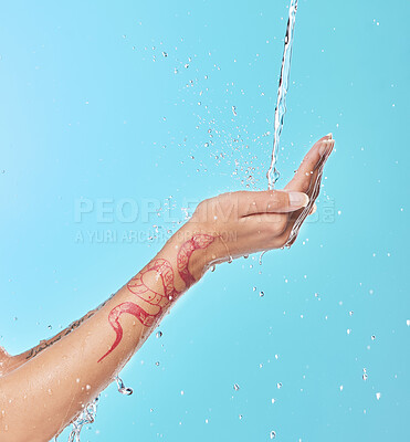 Buy stock photo Shot of an unrecognizable woman enjoying a shower against a blue background