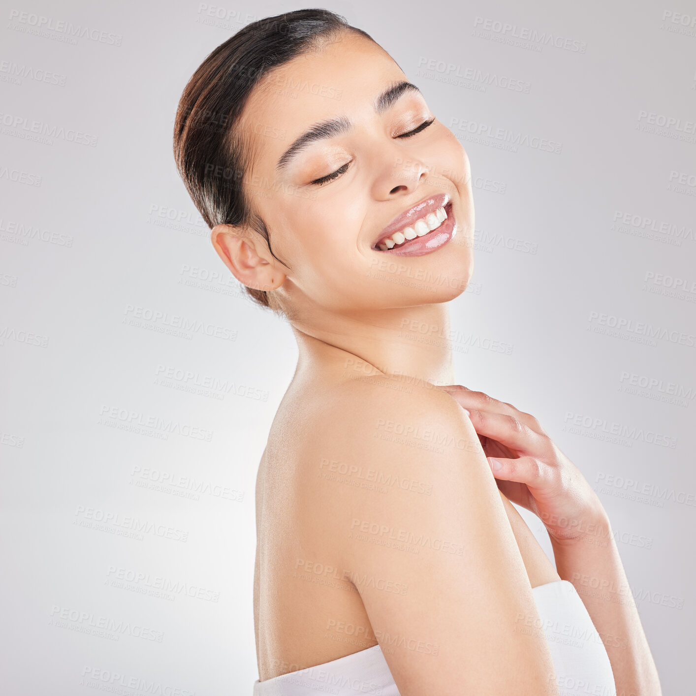 Buy stock photo Shot of a young woman posing against a grey background