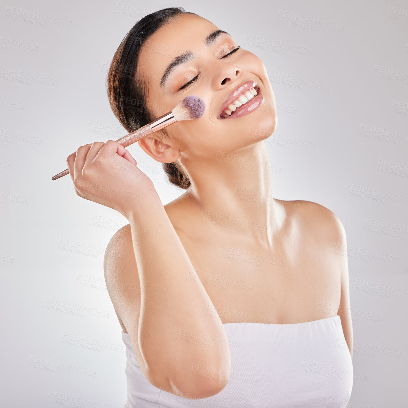 Buy stock photo Makeup brush, happy and woman in studio for blush, cosmetics and application on white background. Female person, beauty and tools with smiling for highlight, contour and skincare with eyes closed