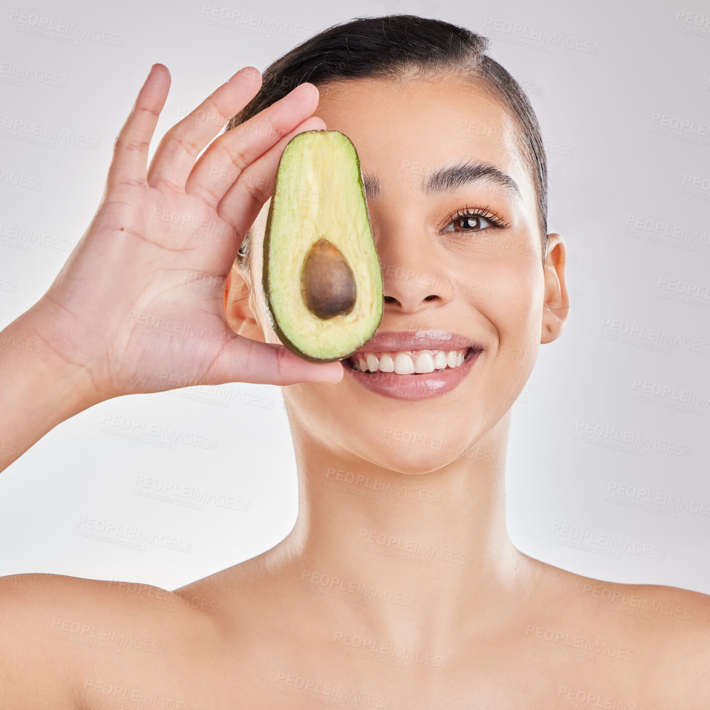 Buy stock photo Studio, face and girl with avocado, smile and fruit for skincare, moisturizing and healthy. White background, hydrate and skin of person, beauty and soothe for facial, wellness and cosmetics for glow