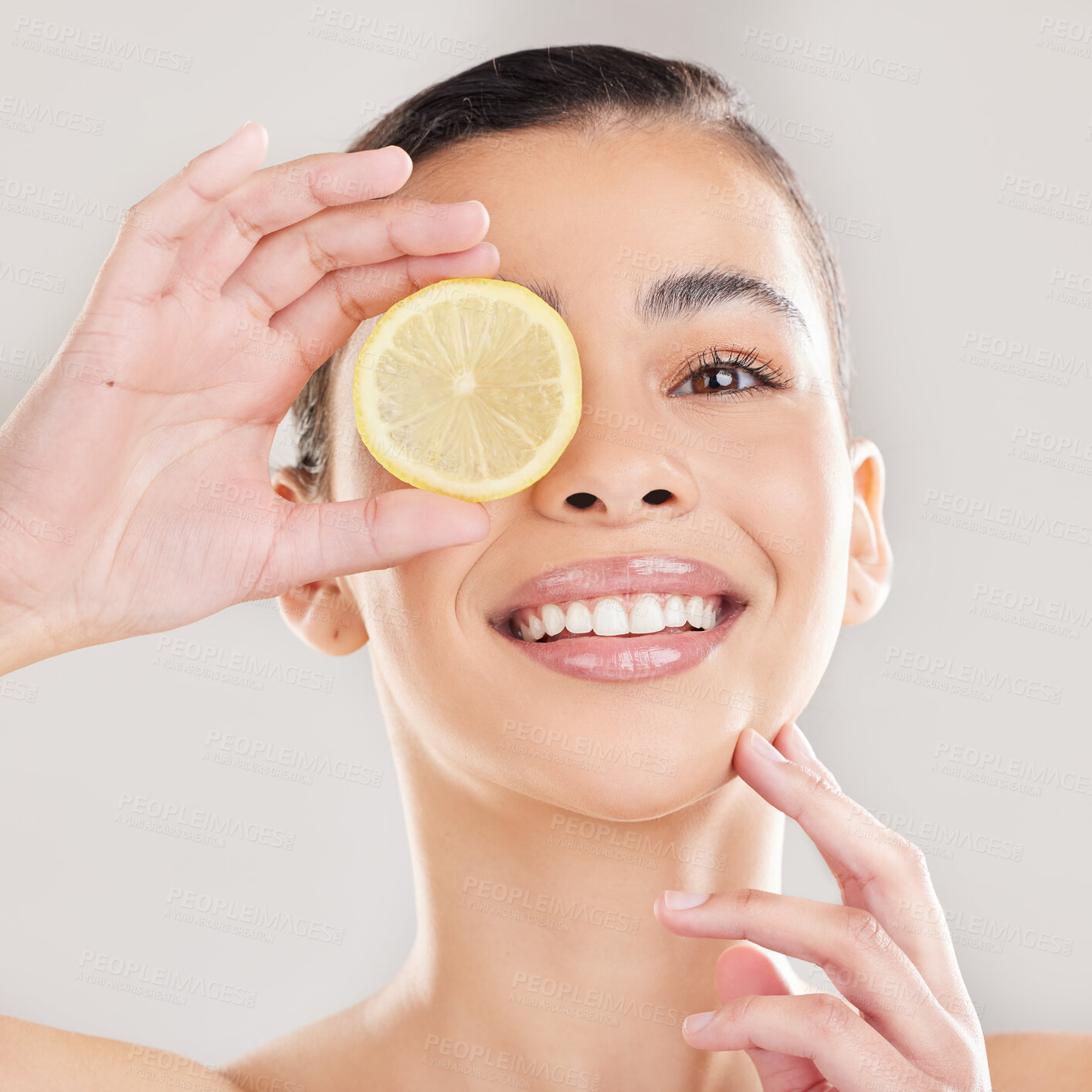 Buy stock photo Studio, lemon and face of woman, skincare and brightening of skin, beauty and wellness with facial. White background, healthy or happiness for person, hand and exfoliate of pores or smile for results