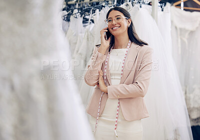 Buy stock photo Phone call, wedding dress and tailor woman in studio for communication or planning. Feedback, style and fashion designer with tape measure talking on mobile in workshop for fitting appointment
