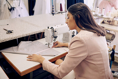 Buy stock photo Shot of a seamstress using a sewing machine while working in her boutique