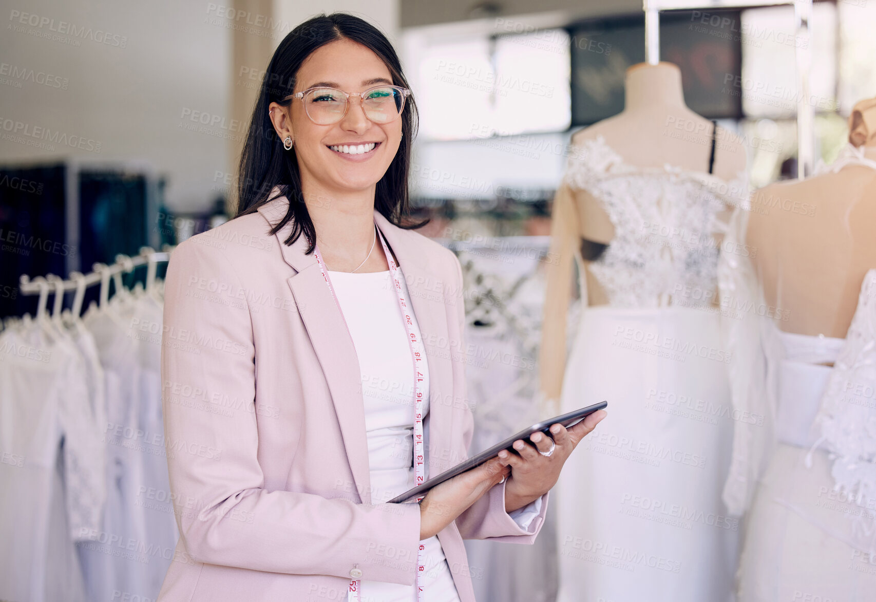 Buy stock photo Portrait, tablet and wedding designer woman in studio for agenda, calendar or planning. Fashion, smile and happy seamstress with tape measure in workshop for appointment, online order or research