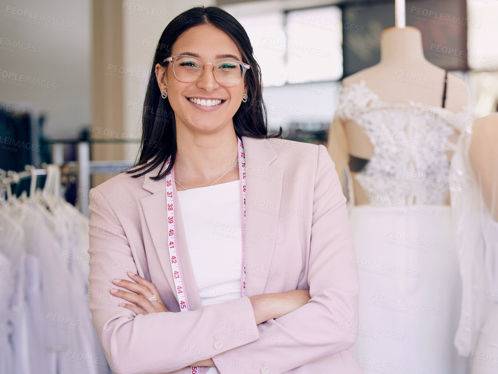 Buy stock photo Shot of an attractive young seamstress working in a bridal boutique