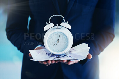 Buy stock photo Cropped shot of an unrecognisable businessman standing alone in the office and holding an alarm clock