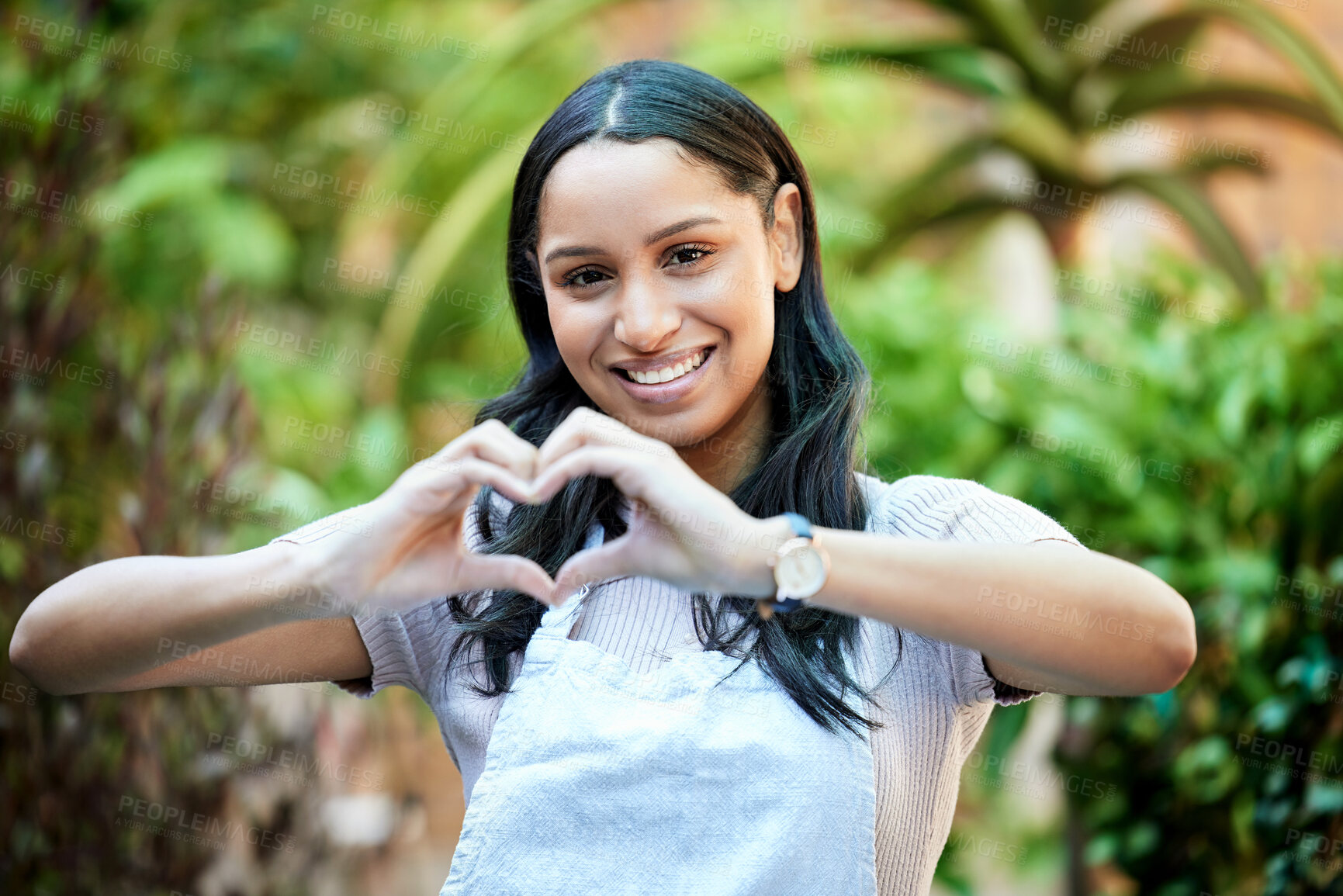 Buy stock photo Heart, hands and woman in portrait at flower shop with love for nature, donation and charity with wellness. Florist in apron, emoji or sign for romance with feedback, reaction or vote at a nursery