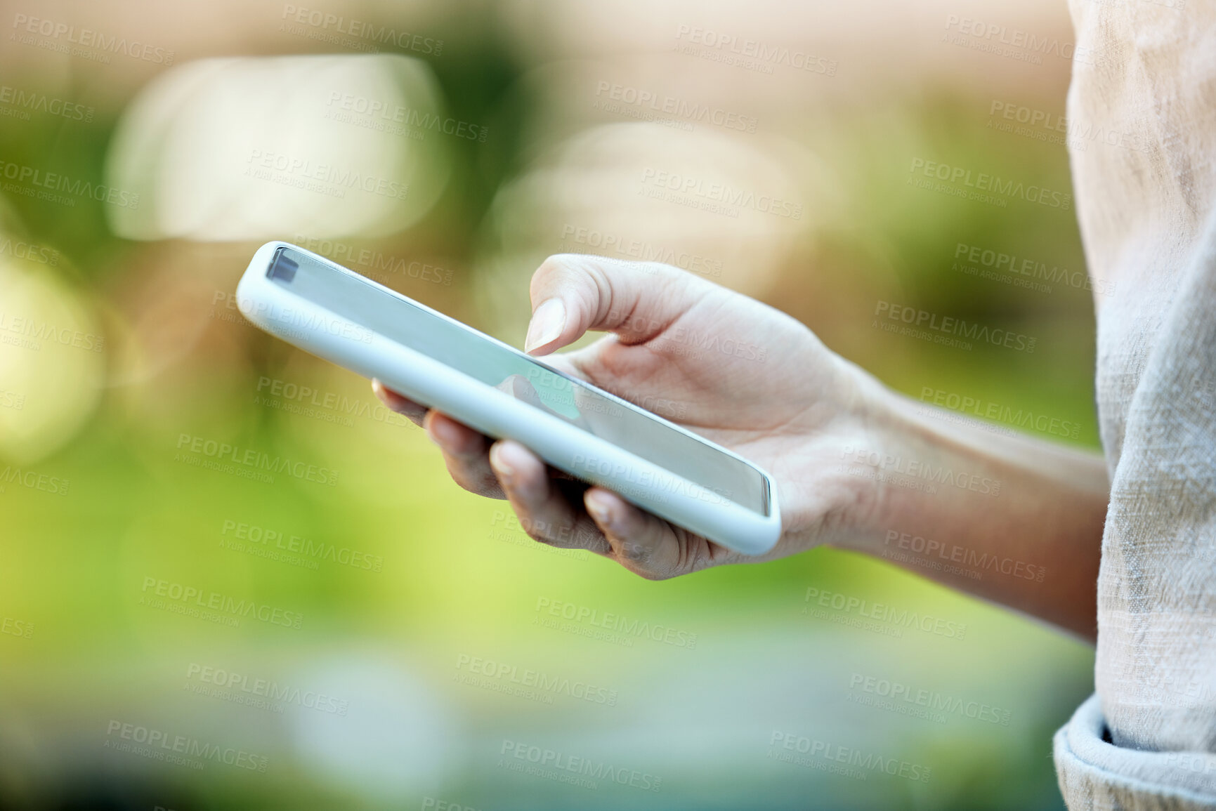 Buy stock photo Person, hand typing and mobile phone in park for social media, communication or networking outdoors. Bokeh, scrolling and closeup of woman with smartphone for connection, browsing internet or contact