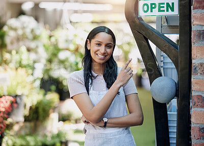 Buy stock photo Happy woman, portrait and open sign at nursery with small business, gardening and sustainability with welcome. Pointing at poster, notice with flower seller or florist, entrepreneur and service
