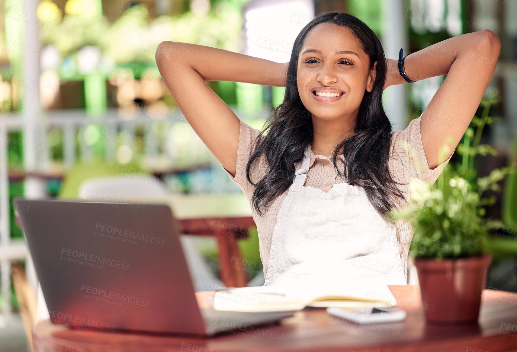 Buy stock photo Shot of a young florist looking happy and relaxed at work